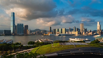 The rooftop garden overlooks the Central-Wan Chai Bypass and onwards to Victoria Harbour and Tsim Sha Tsui Waterfront, with the iconic Lion Rock and mountains at the far eastern end of the Harbour.